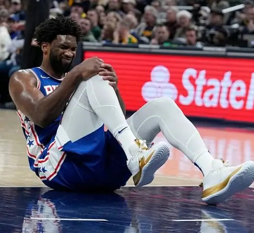 Embiid clutching his knee.